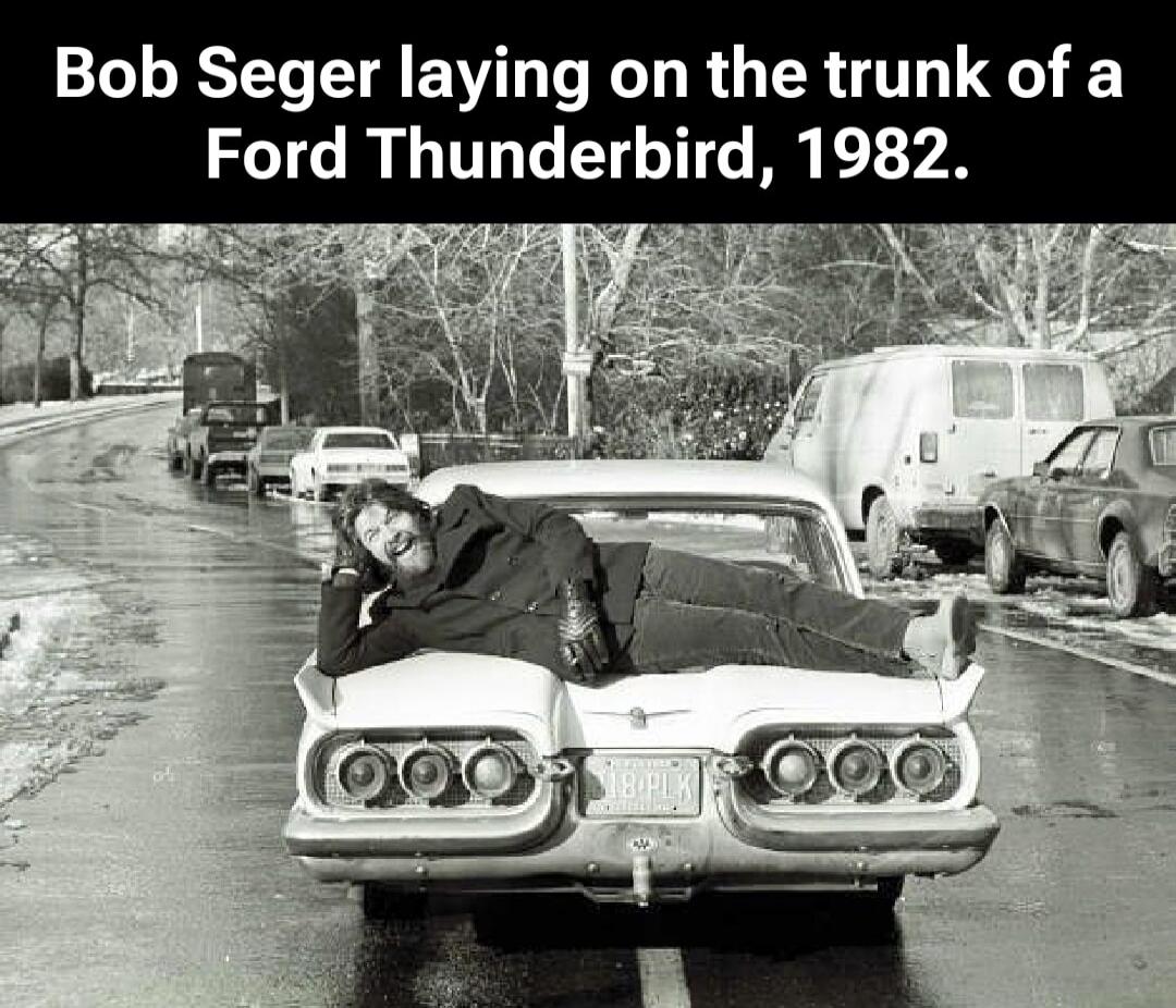 Bob Seger laying on the trunk of a Ford Thunderbird, 1982.