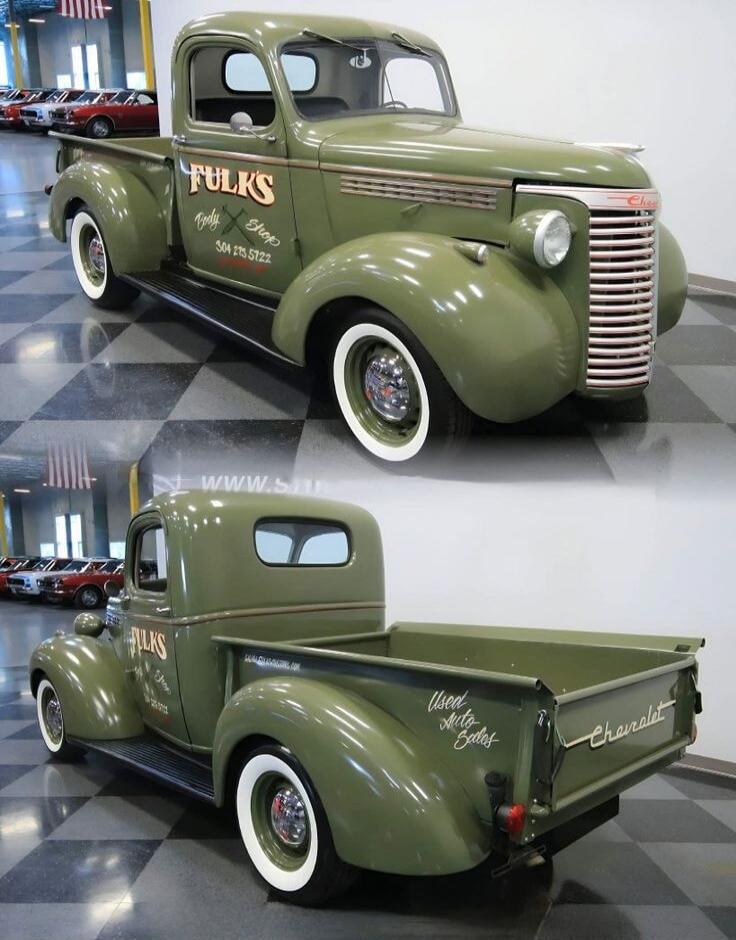 Vintage green pickup truck with whitewall tires. Side lettering reads 'FULKS' (appears on the door). The rear tailgate shows 'Chevrolet'. Some additional script on the door and bed side is present but not fully legible in the image.