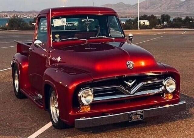 Red classic pickup truck in a parking lot