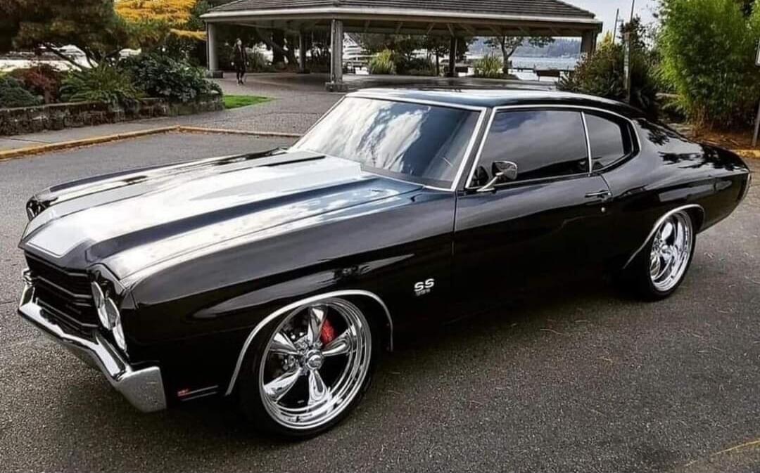 Black 1969 Chevrolet Chevelle SS muscle car with chrome wheels.