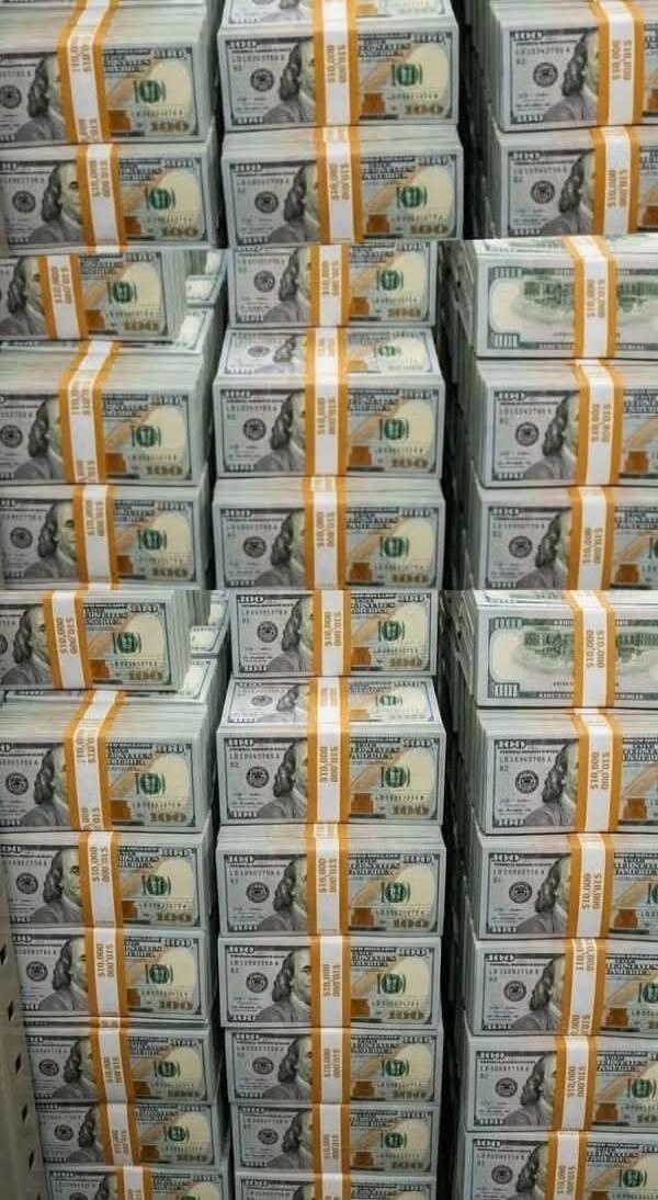 Stacks of one hundred dollar bills. Each stack is bundled with a strap indicating $10,000.
