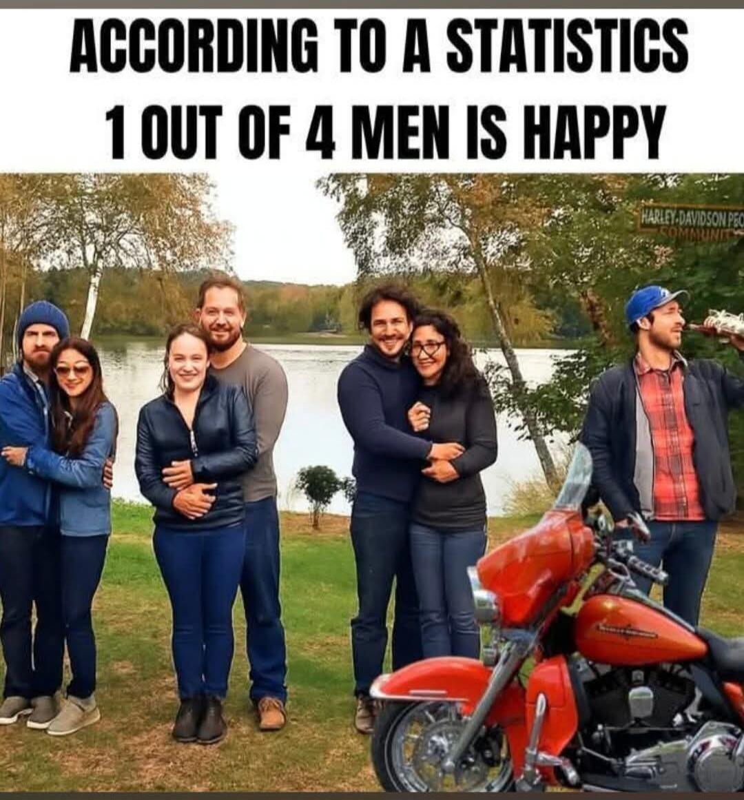 ACCORDING TO A STATISTICS 1 OUT OF 4 MEN IS HAPPY. The image shows three couples standing together by a lake, all appearing content. To the right, a single man stands next to a red Harley-Davidson motorcycle, drinking from a bottle and smiling, implying he is the 'happy man' from the statistic.