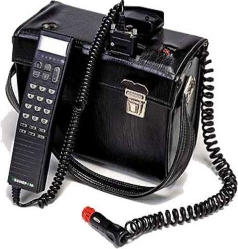 A black leather case with a wired handheld remote keypad and display, attached to a coiled cord and a car cigarette lighter plug.