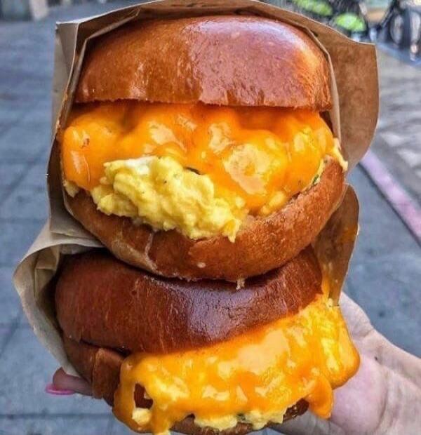 An over-the-top double cheeseburger with melted cheese and egg.