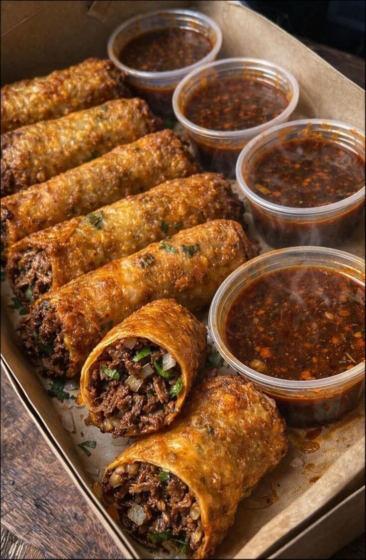 Delicious egg rolls with dipping sauce.