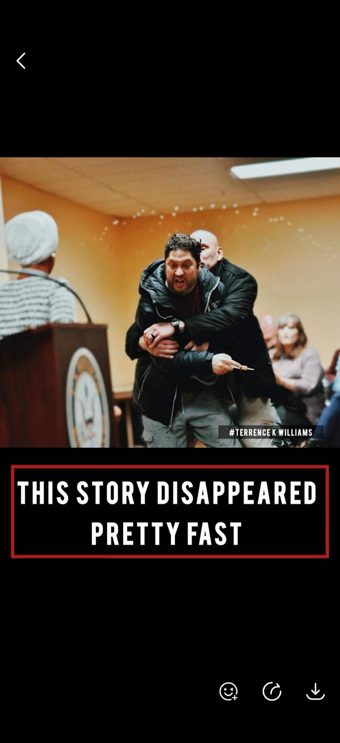 THIS STORY DISAPPEARED PRETTY FAST #TERRENCE K WILLIAMS. A man is being restrained by another man in a public setting, possibly a courtroom or meeting. The restrained man appears angry and is holding a small, syringe-like object.