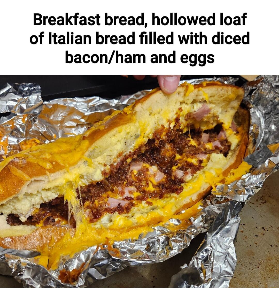 Breakfast bread hollowed loaf of Italian bread filled with diced baconham and eggs