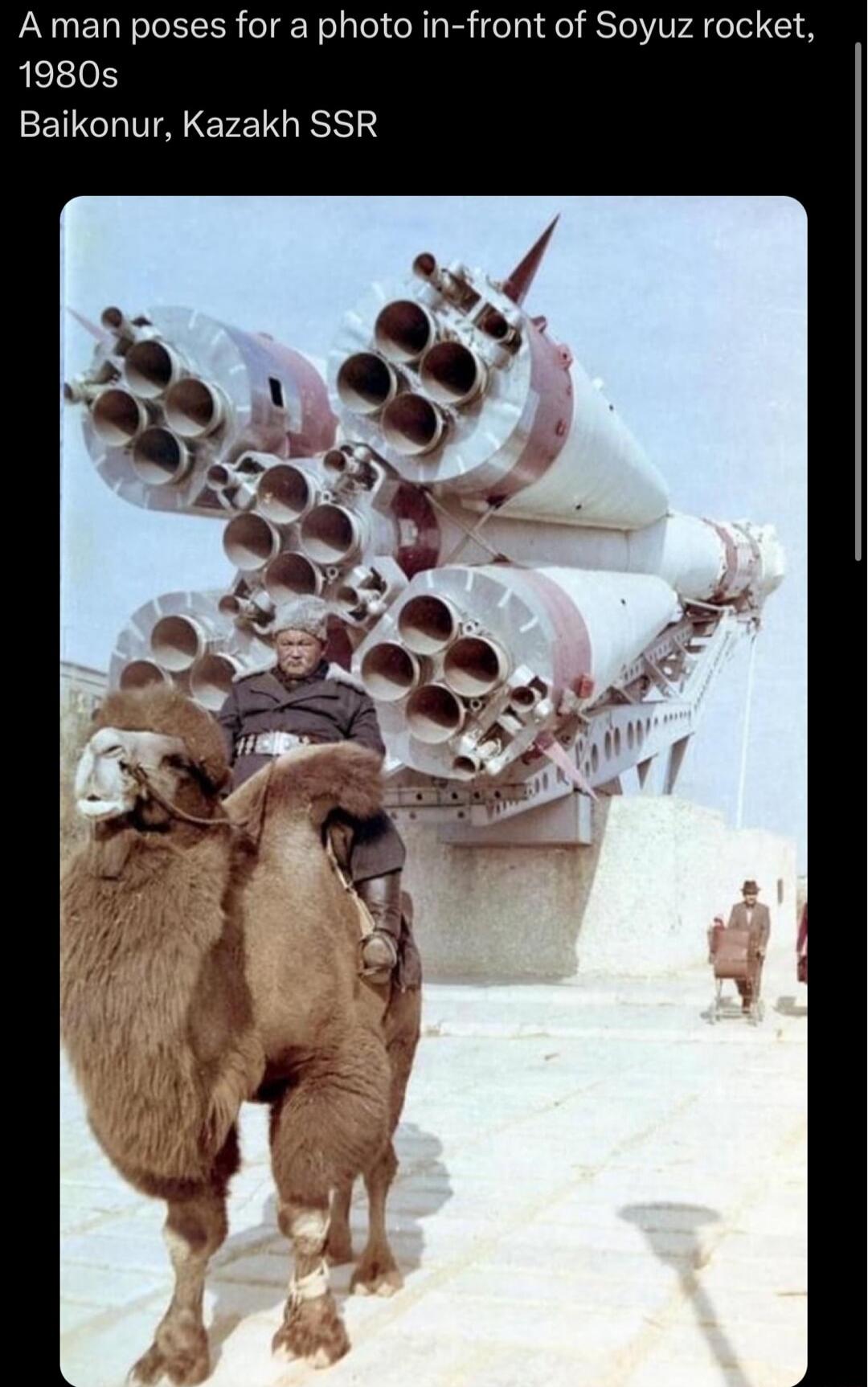 A man poses for a photo in front of Soyuz rocket 1980s Baikonur Kazakh SSR