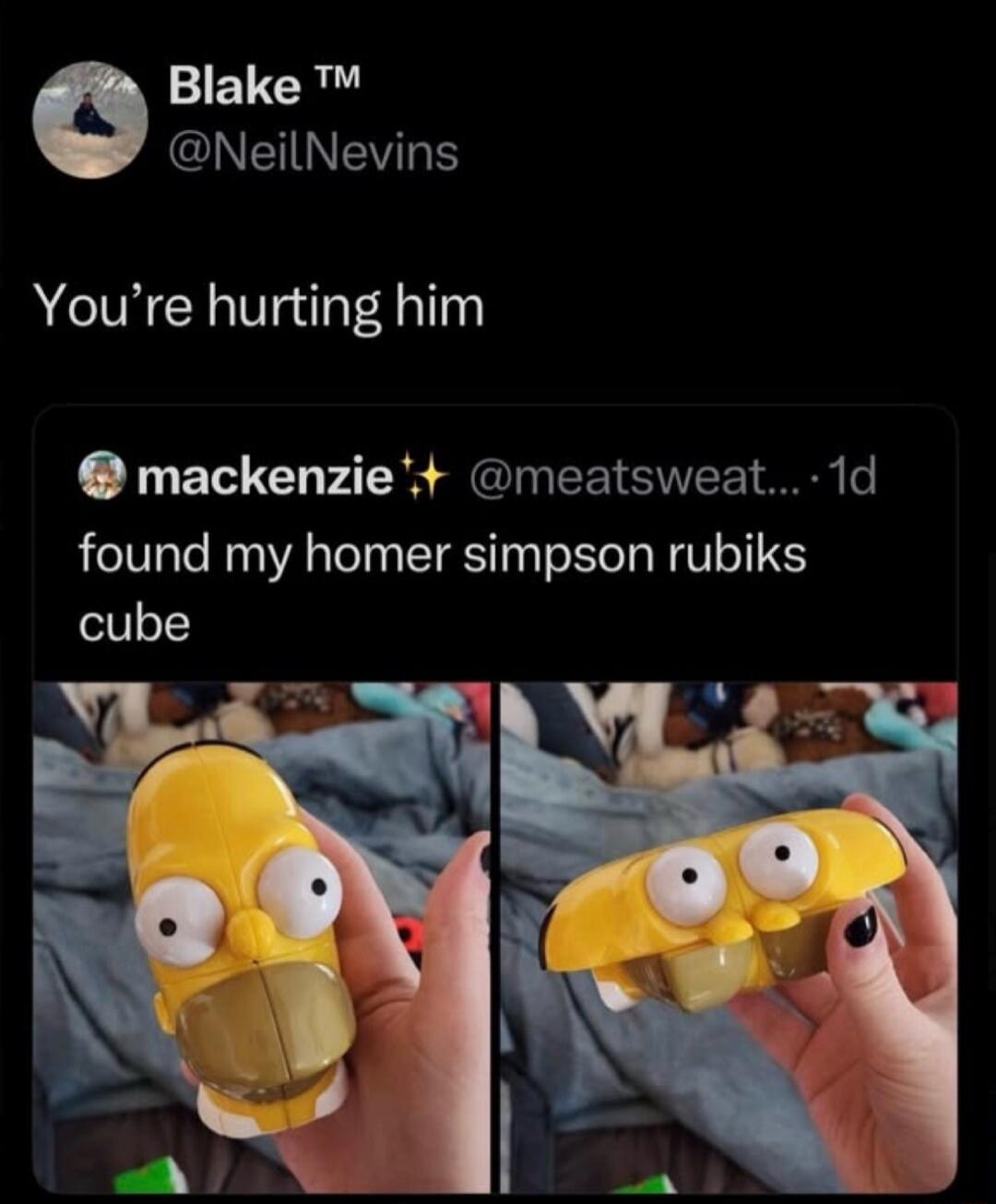 A tweet from Blake ™ @NeilNevins saying 'You're hurting him' in response to a tweet from mackenzie ✨ @meatsweat... 1d that says 'found my homer simpson rubiks cube'. Below the tweets are two images of a Homer Simpson-shaped Rubik's cube, one in its normal head form and another in a squashed, 'solved' form, making Homer look distorted.