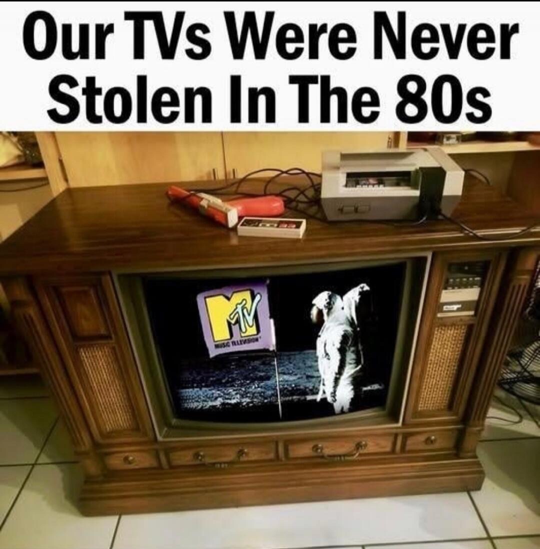 Our TVs Were Never Stolen In The 80s. The image shows an old console television displaying the MTV logo and an astronaut on the moon. An original Nintendo Entertainment System (NES) console and a light gun are placed on top of the TV.