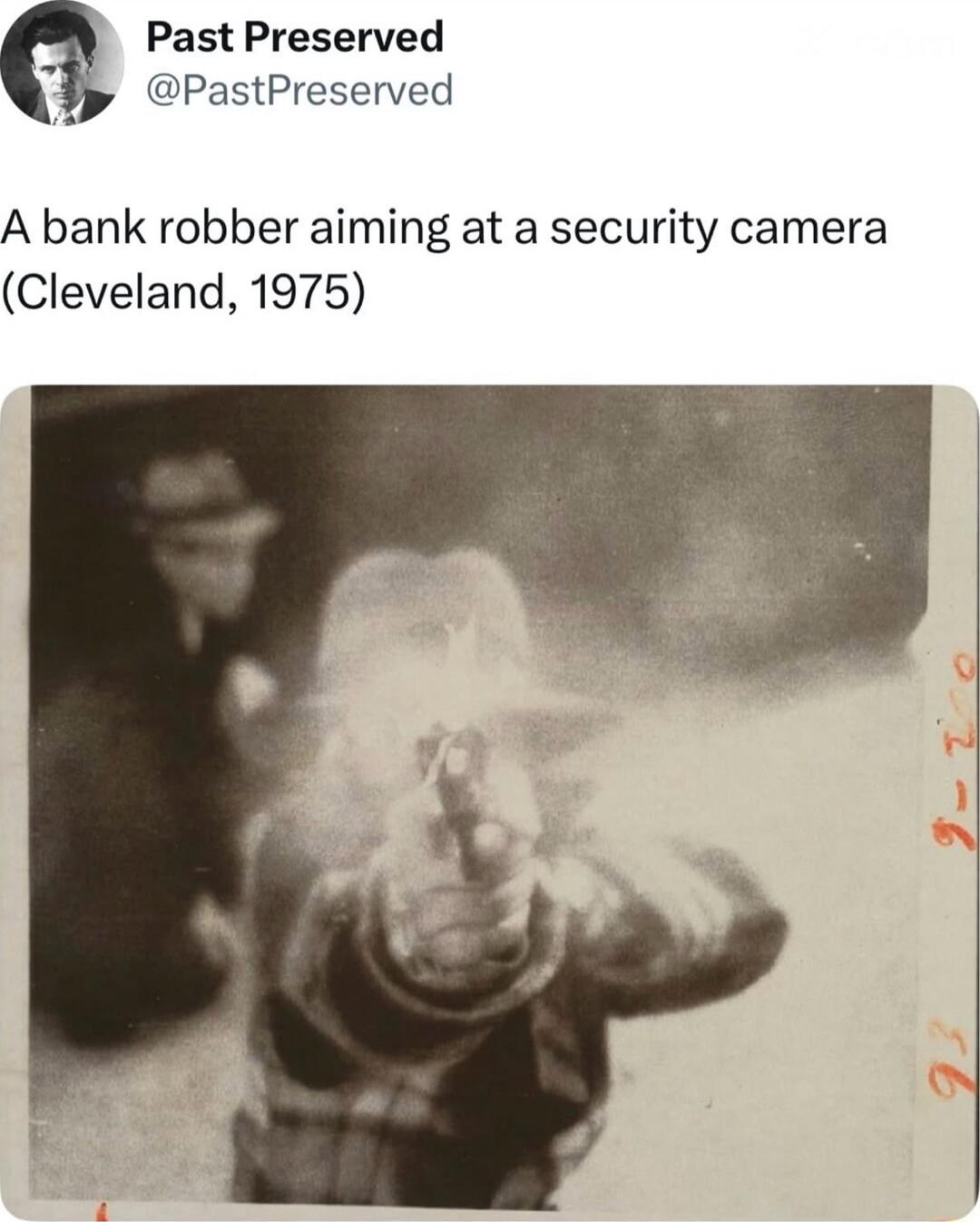 A bank robber aiming at a security camera (Cleveland, 1975)