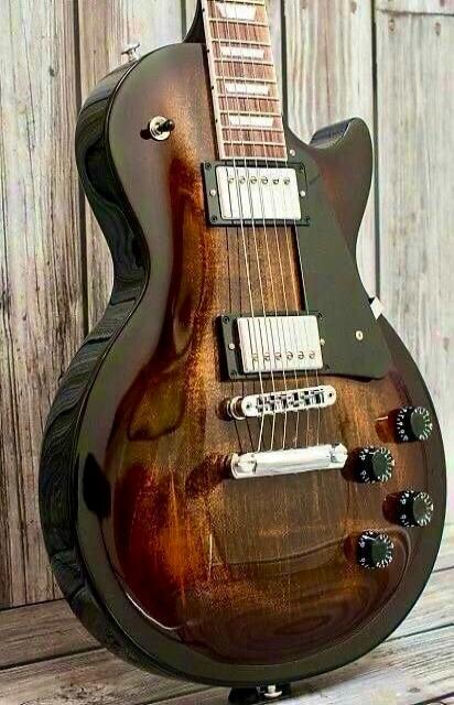 A close-up shot of an electric guitar with a beautiful wooden finish.
