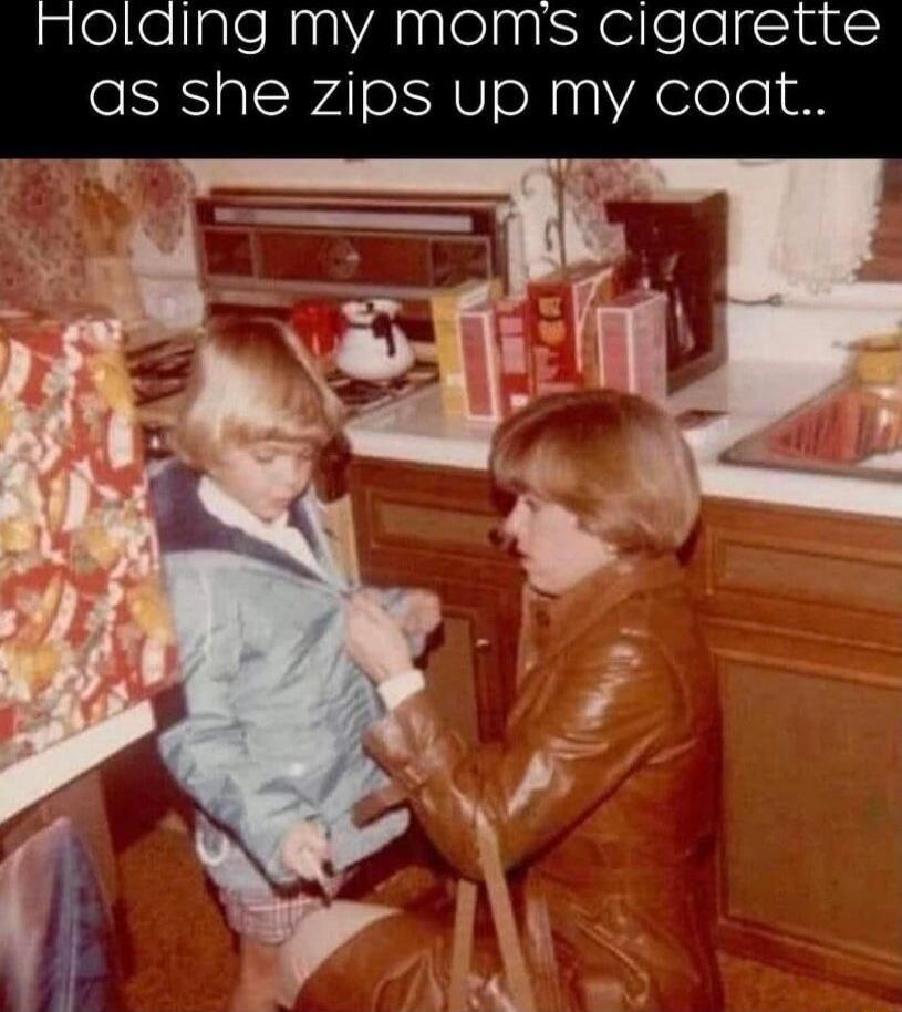 Holding my mom's cigarette as she zips up my coat..