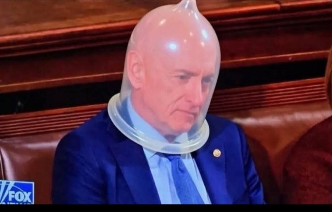 A man in a suit wearing a condom on his head.