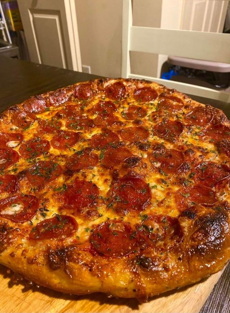 Pepperoni pizza on a wooden surface
