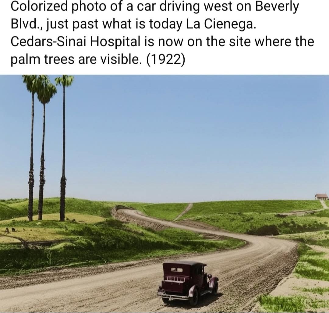 Colorized photo of a car driving west on Beverly Blvd., just past what is today La Cienega. Cedars-Sinai Hospital is now on the site where the palm trees are visible. (1922)