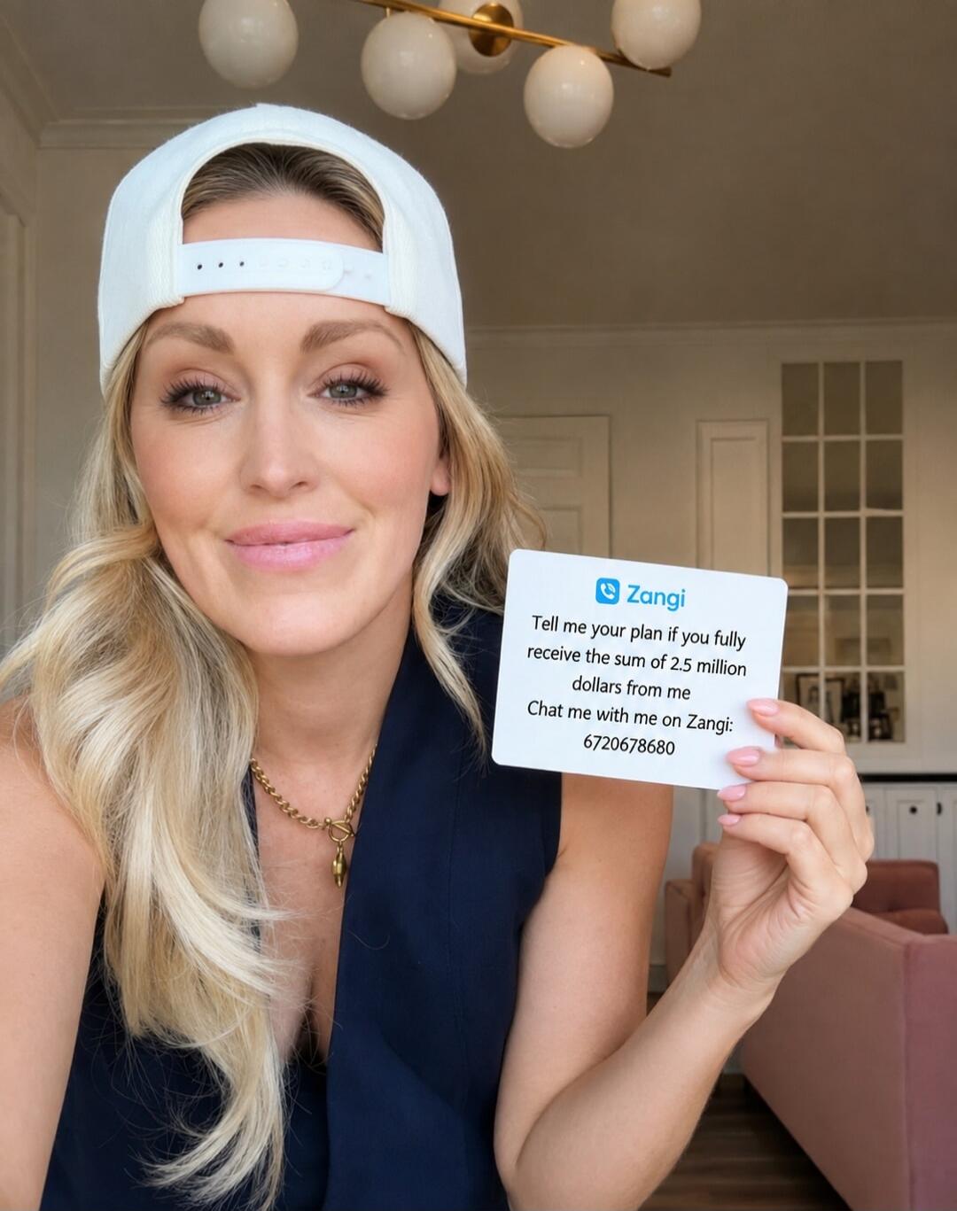 A woman wearing a white cap and a dark blue top is holding a card that says: 'Zangi. Tell me your plan if you fully receive the sum of 2.5 million dollars from me. Chat me with me on Zangi: 6720678680'.