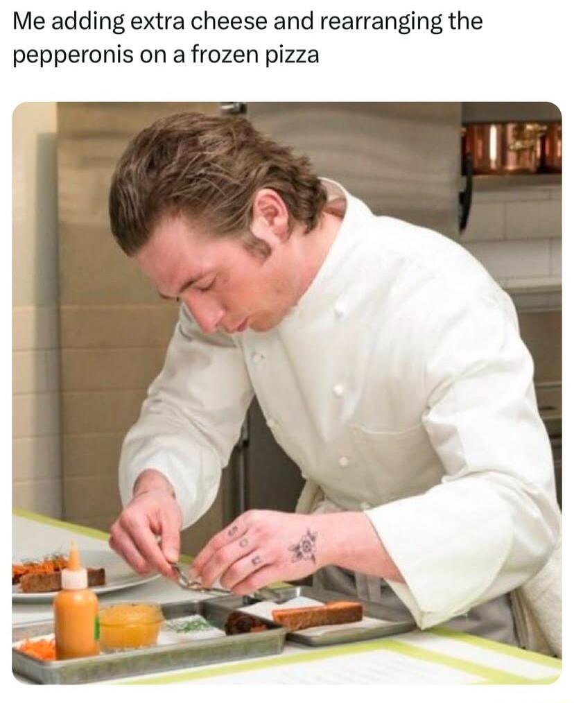 Me adding extra cheese and rearranging the pepperonis on a frozen pizza