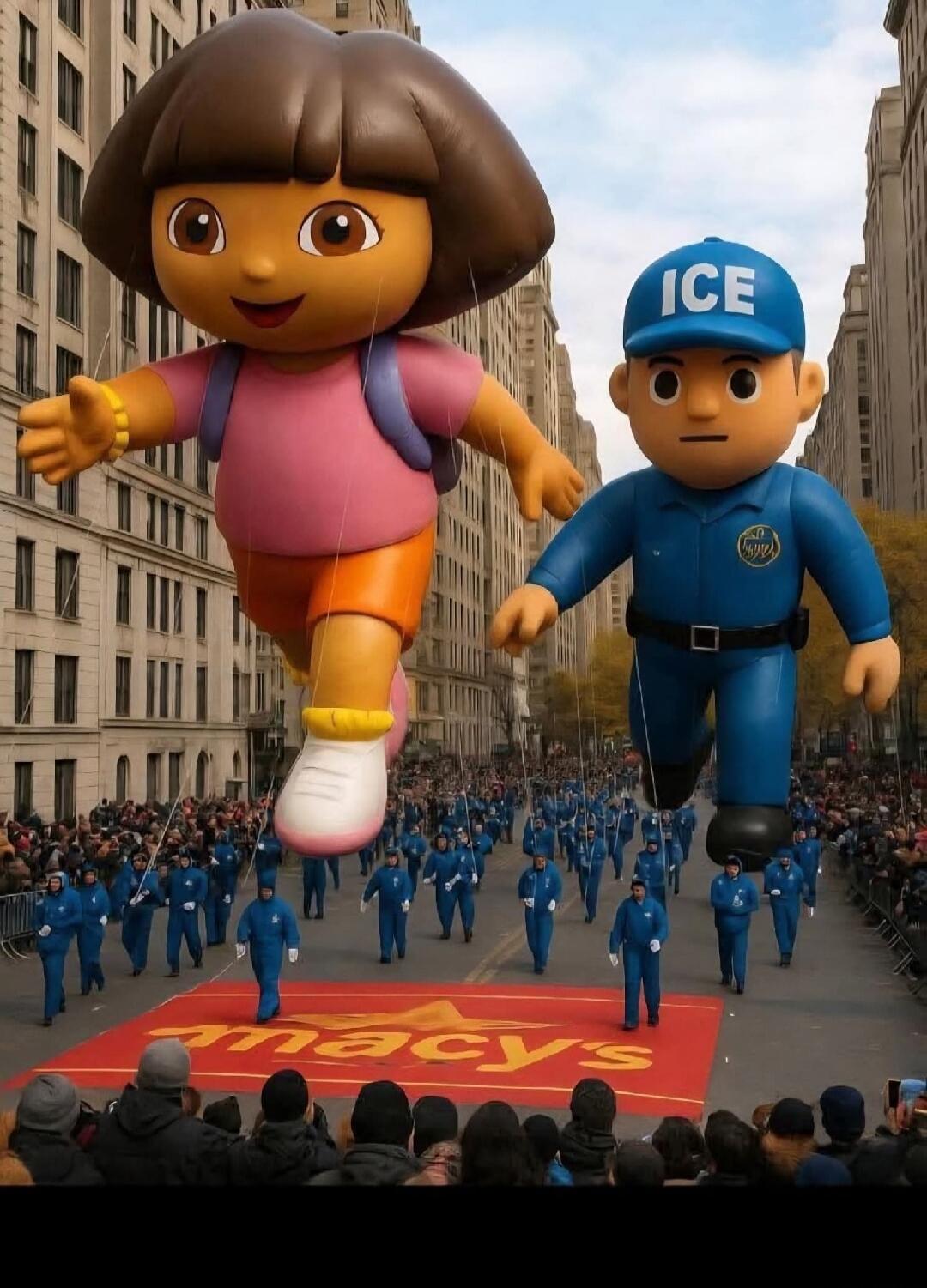Large parade balloons of Dora the Explorer and an ICE officer are seen marching down a city street. The Macy's logo is visible on a red carpet below them. Many people are watching the parade, and handlers in blue uniforms are guiding the balloons.