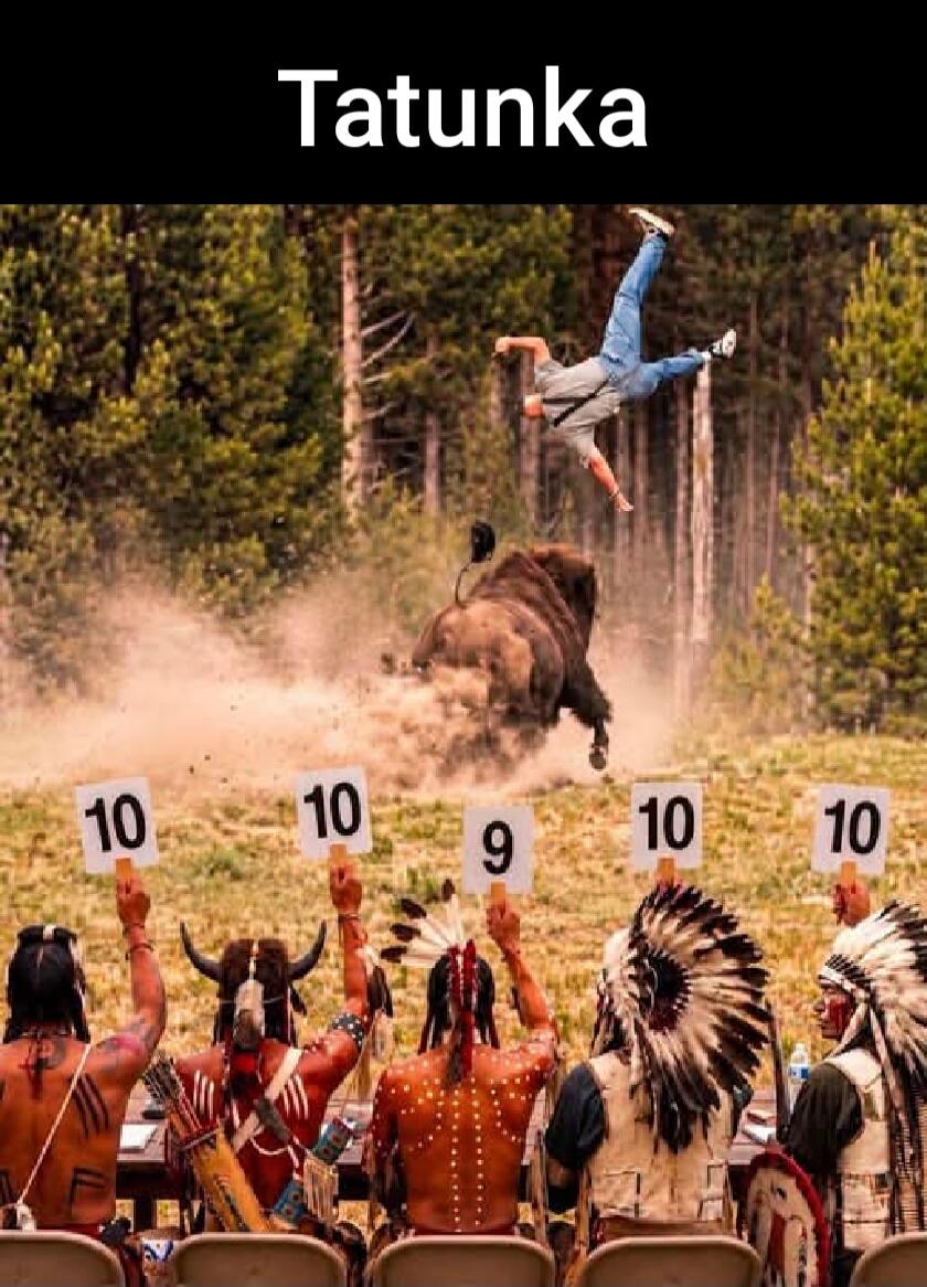 Tatunka. A man is being thrown into the air by a bison, while a panel of judges holds up scorecards with numbers 10, 10, 9, 10.