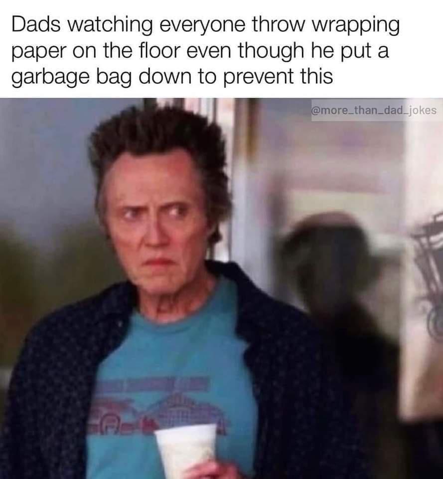 Dads watching everyone throw wrapping paper on the floor even though he put a garbage bag down to prevent this