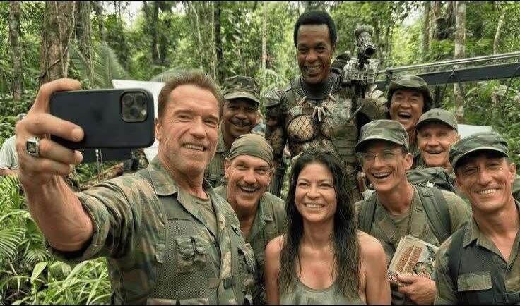Arnold Schwarzenegger takes a selfie with the cast of Predator.