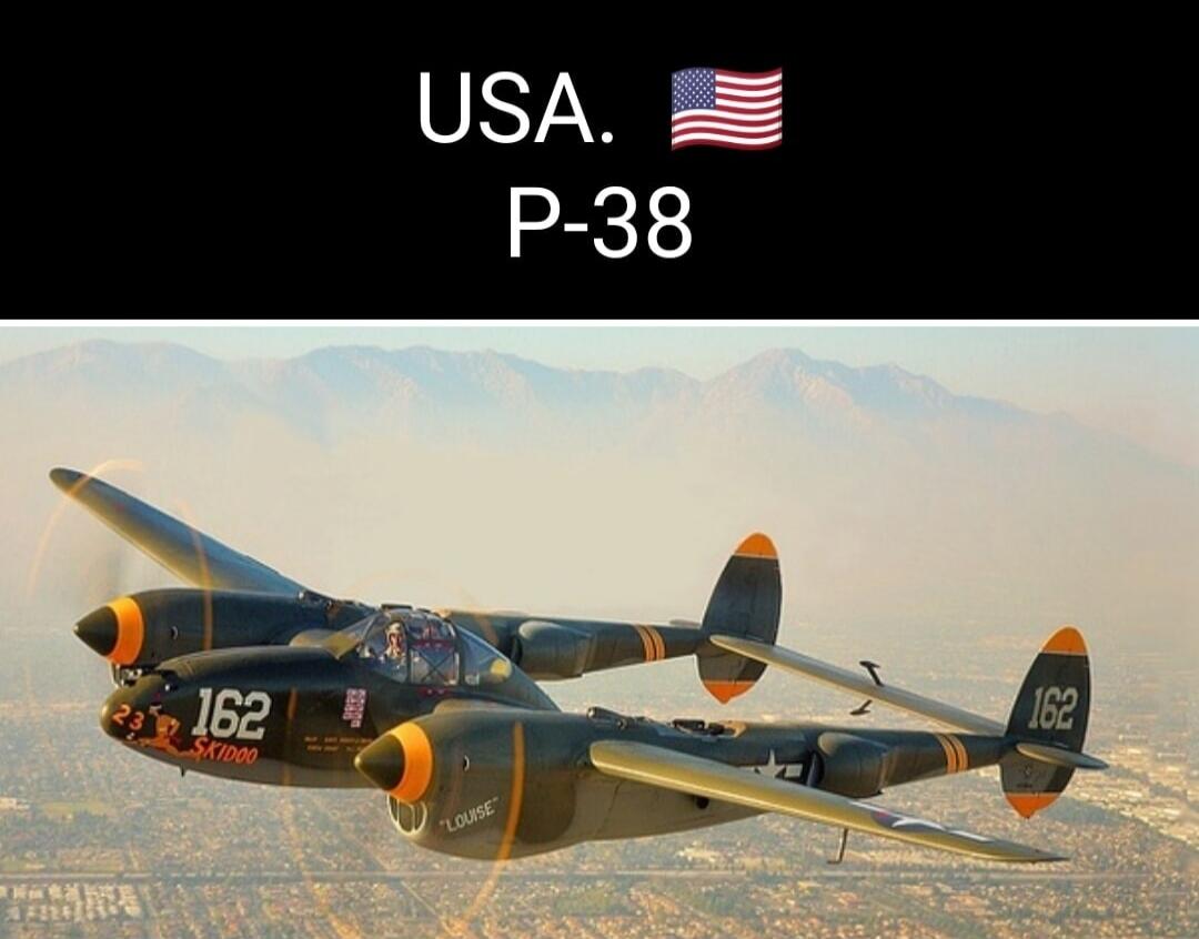 USA. P-38. A P-38 Lightning aircraft with markings '162', 'SKIDOO', and 'LOUISE' flying over a city.