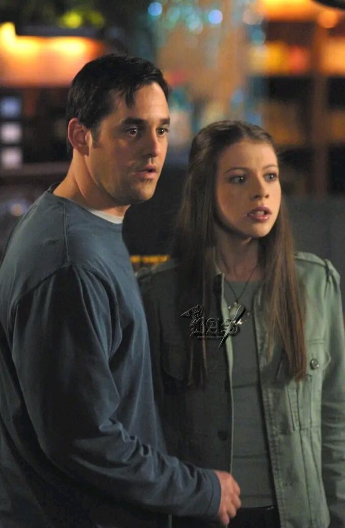 A man and a young woman with surprised or concerned expressions, looking off-camera.