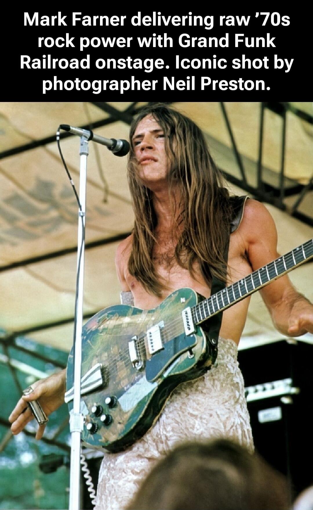 Mark Farner delivering raw '70s rock power with Grand Funk Railroad onstage. Iconic shot by photographer Neil Preston.