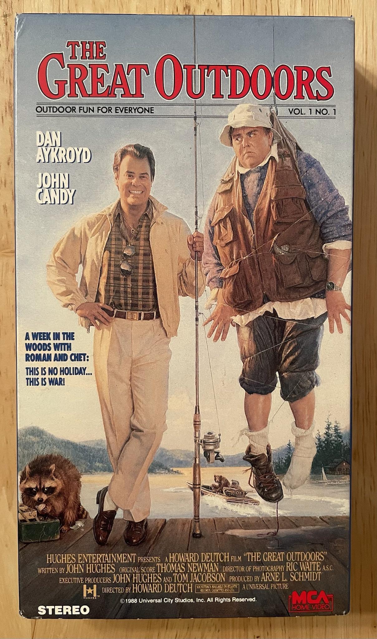 WY 0uTDO0O S T A WEEK IN THE WOODS WITH ROMAN AND CHET THIS IS NO HOLIDAY THIS IS WAR L VOL 1NO1 HUGHES ENTERTAINMENT resexts AHOWARD DEUTCH puy THE GEAT OUTDOORS wrirrex ey JOHN HUGHES orcavayscore THOMAS NEWMAN oigecron of priorociapiy RIC WAITE asc xecunve prooucers JOHN HUGHES ao TOM JACOBSON ero STEREO g7 psyARNE L SCHMIDT INIVERSAL PICTURE