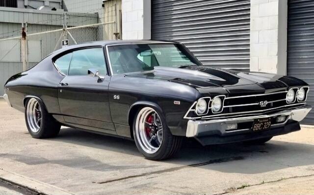 Black 1969 Chevrolet Chevelle SS with custom wheels parked on the street.