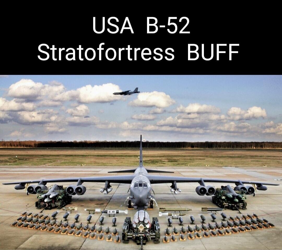USA B-52 Stratofortress BUFF. A B-52 Stratofortress bomber aircraft is displayed on an airfield, surrounded by a vast arsenal of bombs and missiles. Another B-52 is seen flying in the distance.