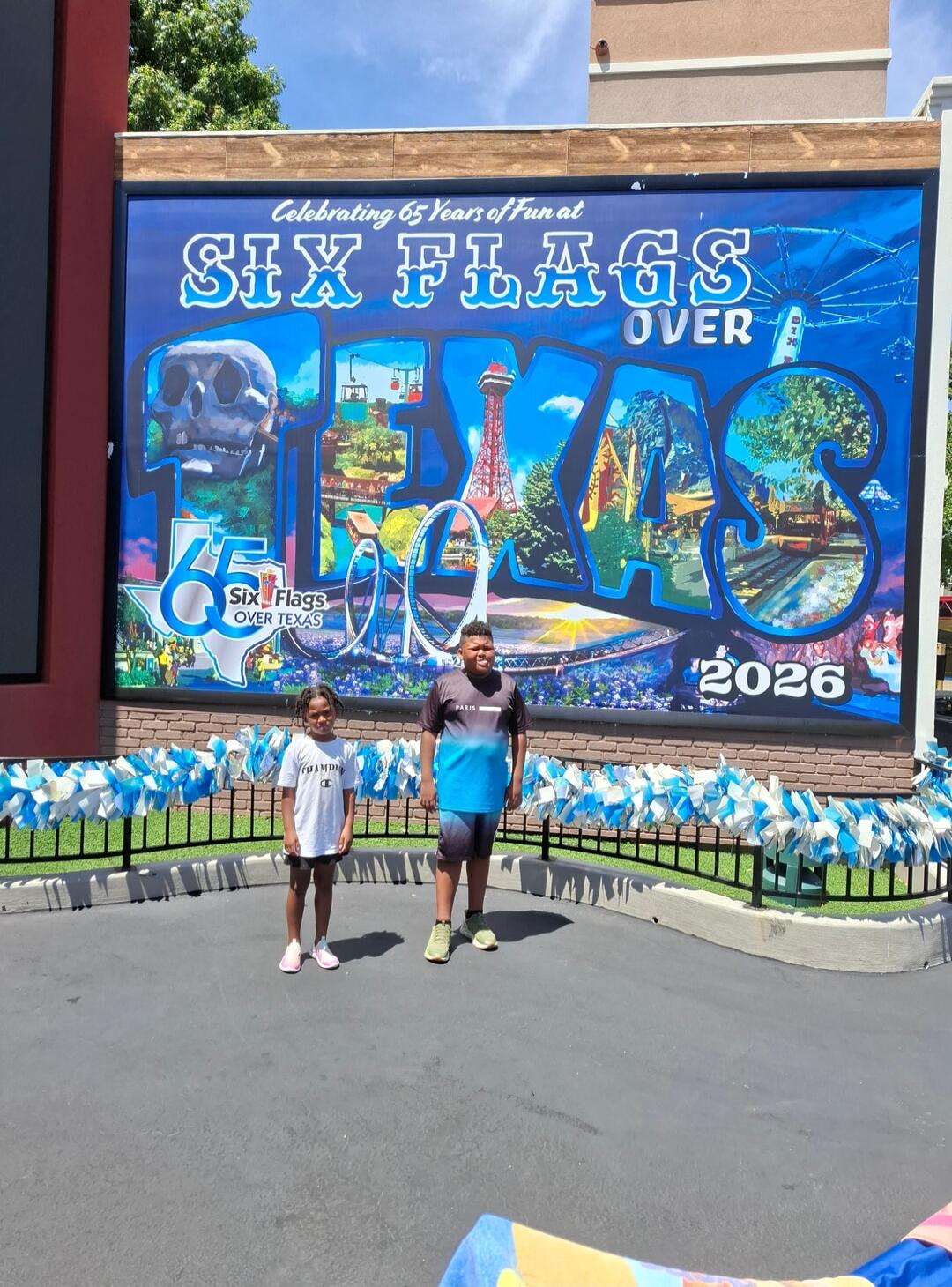 Celebrating 65 Years of Fun at Six Flags Over Texas. The mural also features '65' and '2026' with 'Six Flags OVER TEXAS' written inside the '65' logo.