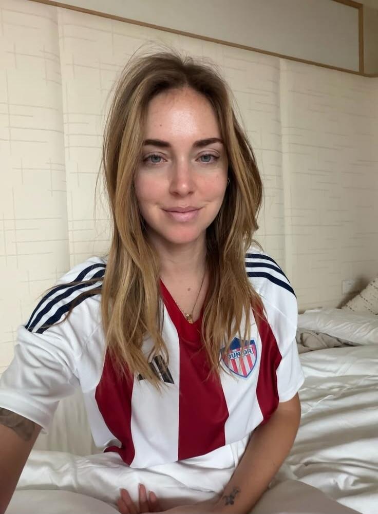 A woman wearing a red and white striped t-shirt with 'JUNIOR' written on it.