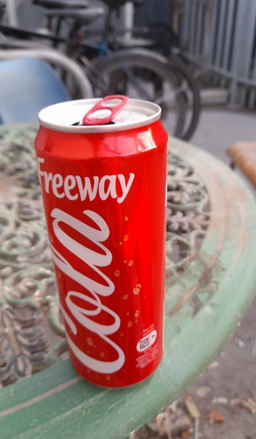Coca-Cola can on a table outdoors