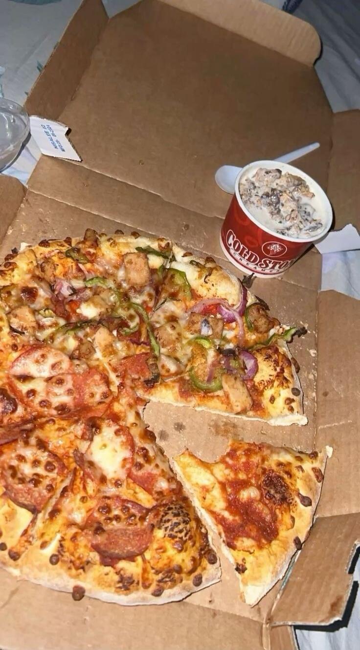 Cold Stone Creamery ice cream and a pizza with various toppings, including pepperoni, chicken, peppers, and onions, served in a cardboard box.