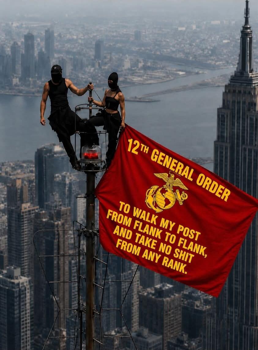 Two individuals, dressed in black and wearing balaclavas, are perched high on a structure, possibly an antenna, atop a skyscraper. They are holding a large red flag that displays the text: '12TH GENERAL ORDER' with the US Marine Corps emblem (eagle, globe, and anchor), and the phrase 'TO WALK MY POST FROM FLANK TO FLANK, AND TAKE NO SHIT FROM ANY R