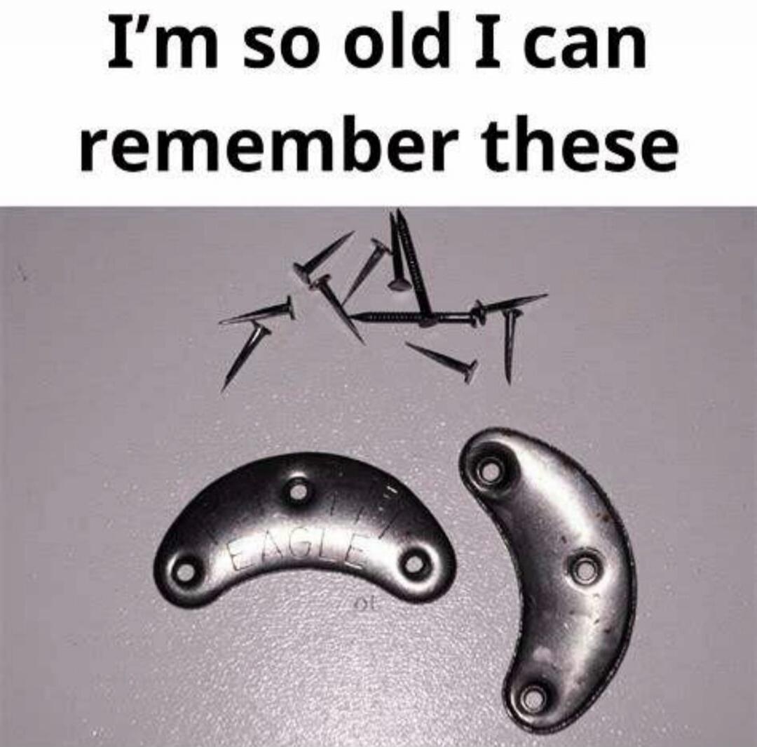 I'm so old I can remember these. The image displays metal shoe heel plates, also known as taps, along with small nails used for attachment. One of the plates has the word 'EAGLE' embossed on it.