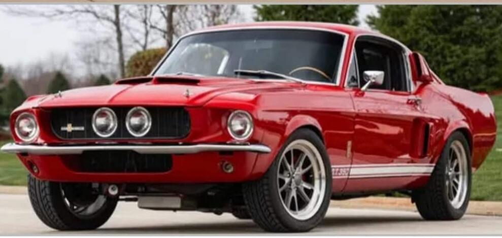 A classic red Ford Mustang Shelby GT350 parked outdoors.