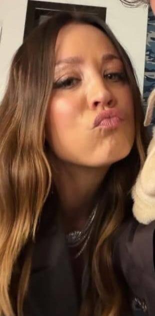A woman making a kiss face, pouting her lips.