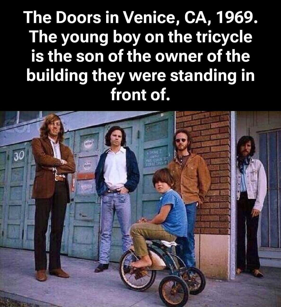 The Doors in Venice, CA, 1969. The young boy on the tricycle is the son of the owner of the building they were standing in front of.
