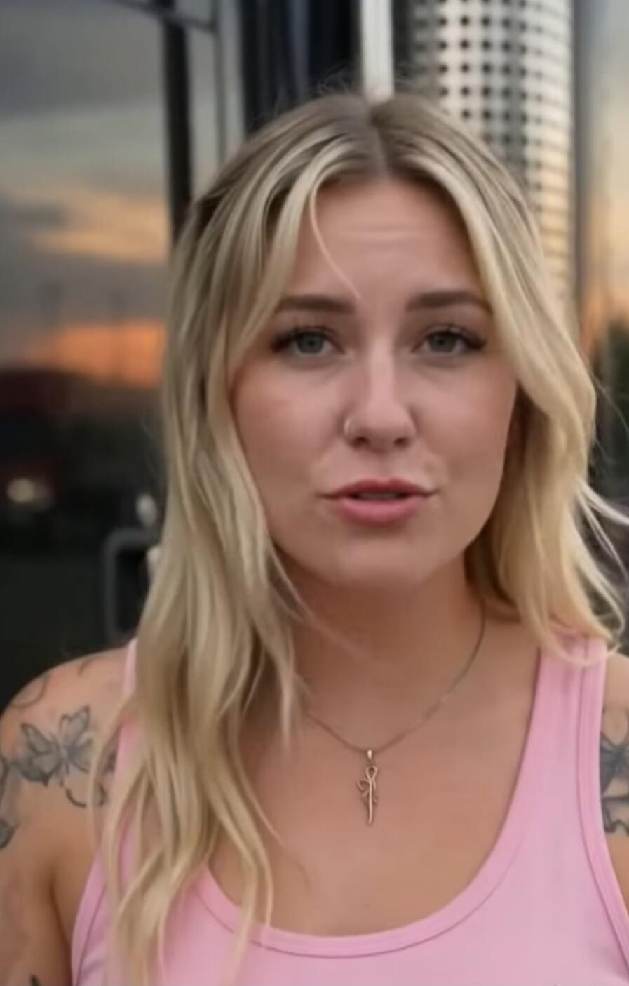 A young blonde woman is speaking directly to the camera, sharing her thoughts or experiences.