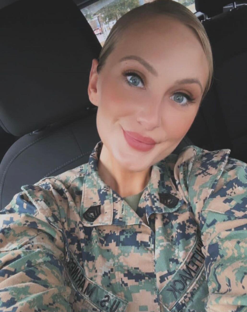 A woman in a US Marine Corps uniform. Text on uniform: MILLEVOCK.