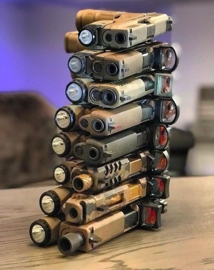 Stack of pistols with lights and optics