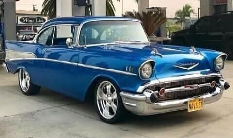 The image shows a classic blue Chevrolet Bel Air car.