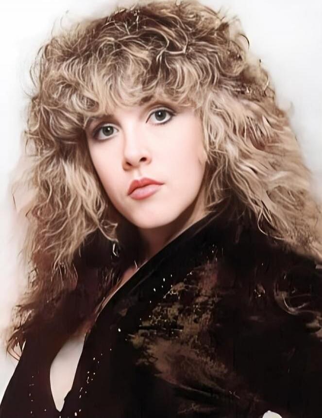 Portrait of a woman with voluminous curly hair.