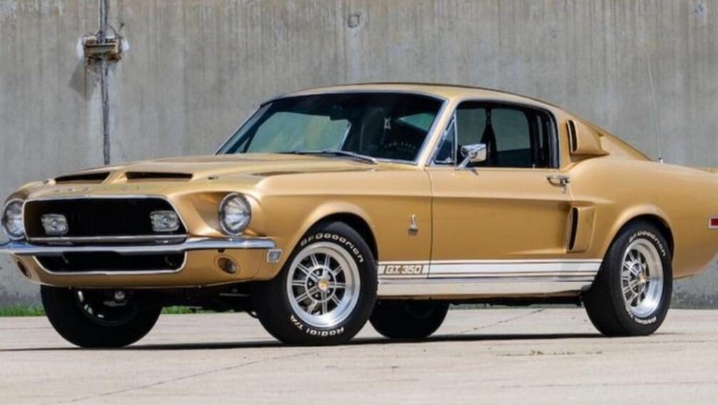 A classic gold Ford Mustang GT 350, a vintage American muscle car.