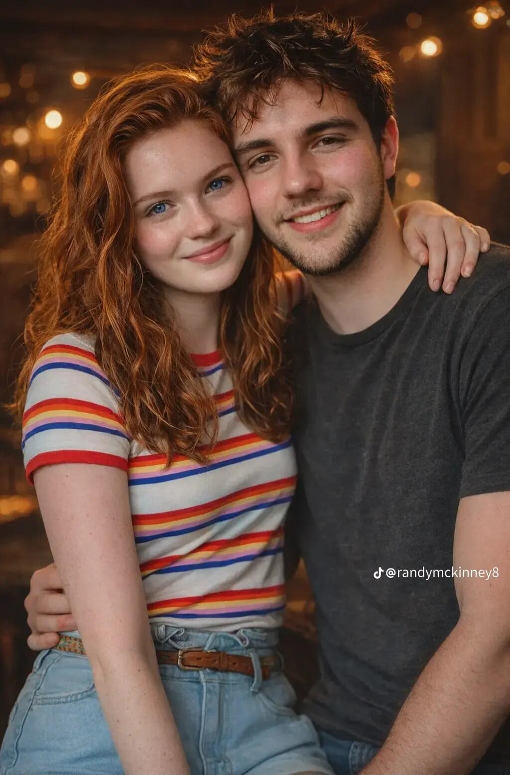 @randymckinney8 A young couple smiling and embracing, looking happy and affectionate.