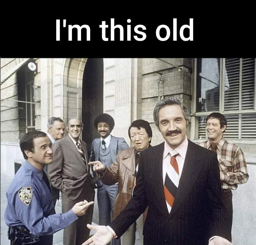 I'm this old. A group of male actors from the 1970s TV show Barney Miller, including Hal Linden as Captain Barney Miller and Max Gail as Detective Stan Wojciehowicz, are standing outside a building. The image is a meme about recognizing classic television.