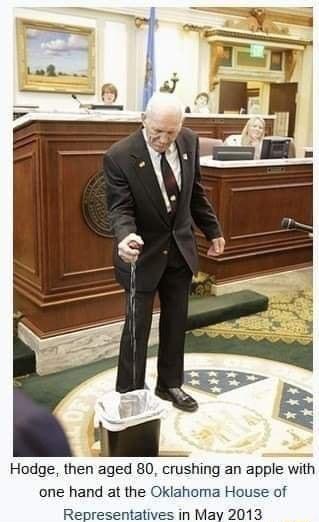 Hodge then aged 80 crushing an apple with one hand at the Oklahoma House of Representatives in May 2013